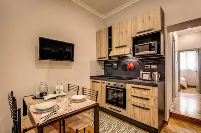 a kitchen with a table and a dining room at Appartamento via del Pantheon in Rome