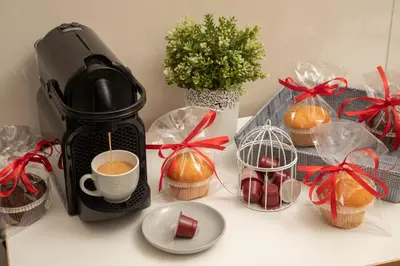 a coffee maker sitting on a counter with wrapped presents at Vatican 84 in Rome