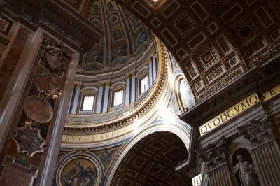 a large room with a ceiling with paintings on it at Vatican 84 in Rome