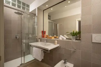 a bathroom with a sink and a shower and a mirror at Vatican 84 in Rome