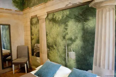 a bedroom with a wall with a painting of trees at Suites Trastevere in Rome