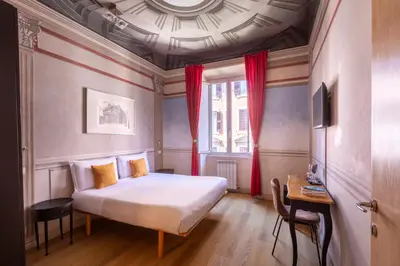a bedroom with a large bed and a window at Suites Trastevere in Rome