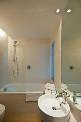 a bathroom with a sink and a tub and a toilet at Little Queen Suite in Rome