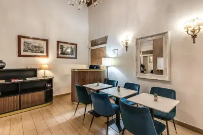 a restaurant with two tables and chairs and a mirror at Little Queen Suite in Rome