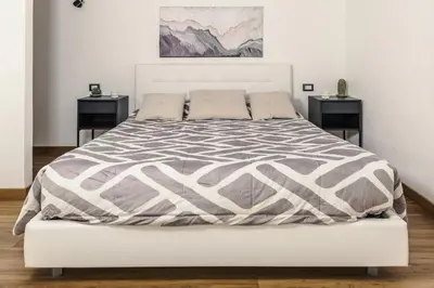a bedroom with a large bed with two night stands at Nvmen Apartment con Terrazza al Colosseo in Rome