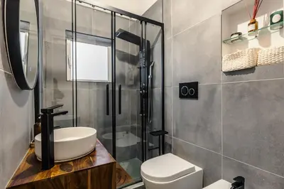a bathroom with a shower and a toilet and a sink at Nvmen Apartment con Terrazza al Colosseo in Rome