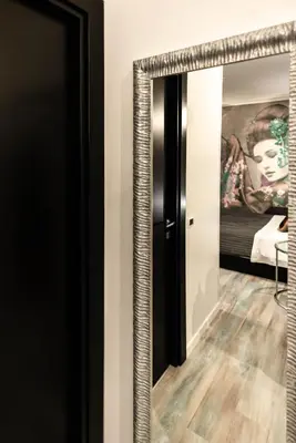 a mirror in a room with a painting at Trevi & Pantheon Design Rooms in Rome
