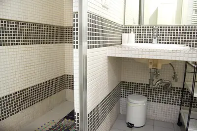 a bathroom with black and white tiles and a sink at Domus Mazzini in Rome