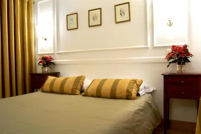 a bedroom with a bed with two pillows on it at Domus Mazzini in Rome