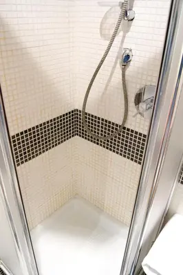 a shower with a hose in a bathroom at Domus Mazzini in Rome