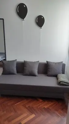 a couch sitting on a wooden floor in a room at Pepe's Place - Re di Roma in Rome