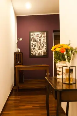 a living room with a table and a bench at Pepe's Place - Re di Roma in Rome