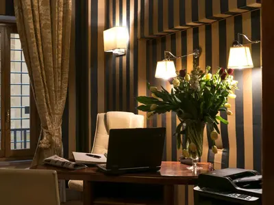 a room with a desk with a laptop and a chair at IG Suites in Rome