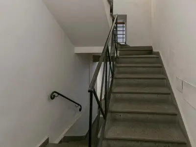 a staircase in a building with a metal railing at IG Suites in Rome