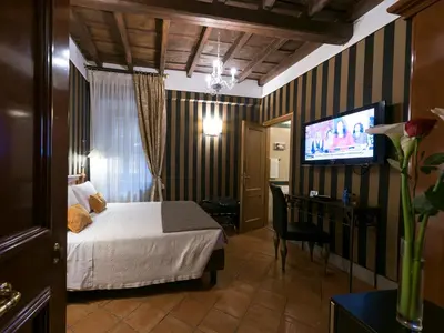 a hotel room with a bed and a television at IG Suites in Rome