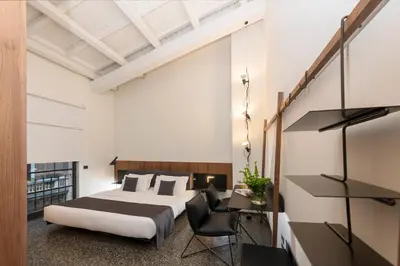 a bedroom with a bed and a desk and a chair at Hotel Royal Bissolati in Rome