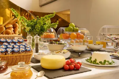 a table topped with plates of food and fruit at Hotel Royal Bissolati in Rome