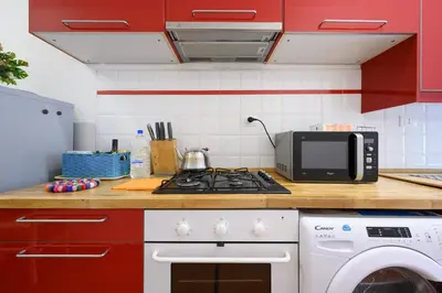 a kitchen with a stove top oven next to a microwave at Monserrato Apartment in Rome