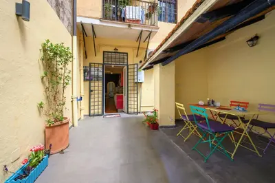 a patio with a table and chairs in a building at Monserrato Apartment in Rome