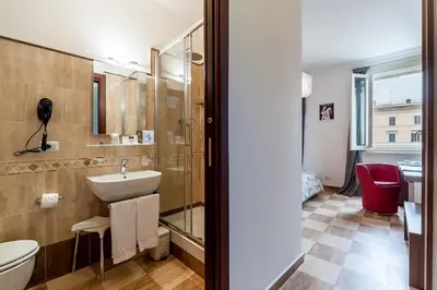 a bathroom with a sink and a toilet at La Dolce Vita Barberini in Rome