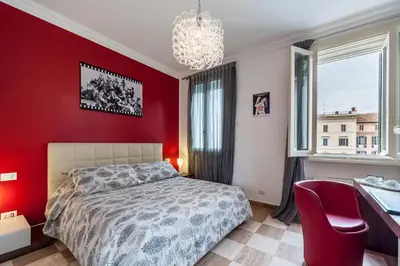 a bedroom with red walls and a bed and a desk at La Dolce Vita Barberini in Rome