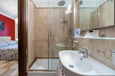 a bathroom with a shower and a sink and a tub at La Dolce Vita Barberini in Rome