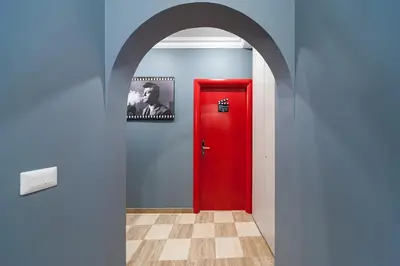 an archway with a red door in a hallway at La Dolce Vita Barberini in Rome