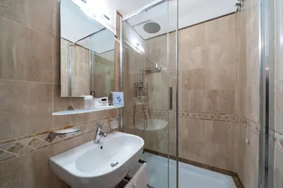 a bathroom with a sink and a shower at La Dolce Vita Barberini in Rome