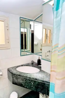 a bathroom with a sink and a large mirror at Hotel Cervia in Rome