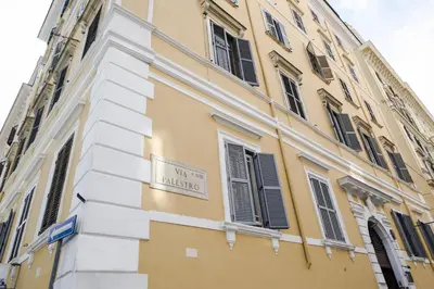 a yellow building with a sign on the side of it at Hotel Cervia in Rome