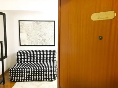 a room with a chair next to a door at Appartamento con magnifico terrazzo vicino a Metropolitana e Vaticano in Rome