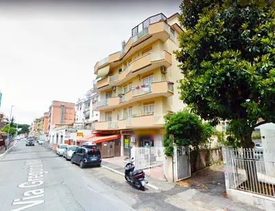 a yellow building on the side of a street at Appartamento con magnifico terrazzo vicino a Metropolitana e Vaticano in Rome