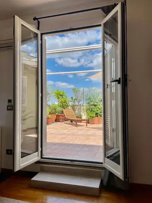 an open door with a view of a patio at Appartamento con magnifico terrazzo vicino a Metropolitana e Vaticano in Rome