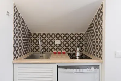 a kitchen with a sink and a counter top at Quiet pied a terre with terrace in Borgo Pio in Rome
