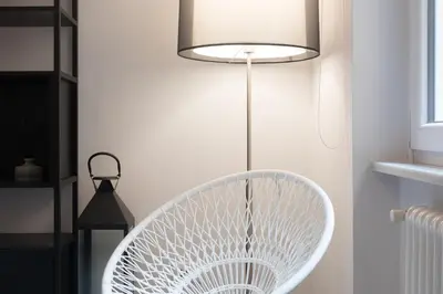 a white fan in a room with a lamp at Quiet pied a terre with terrace in Borgo Pio in Rome