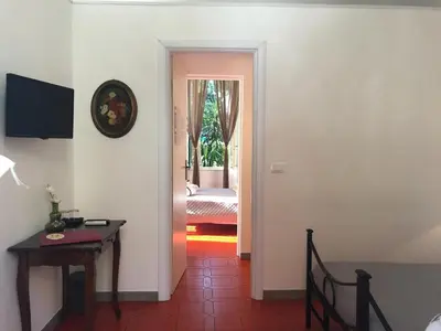 a hallway with a room with a table and a bedroom at Il Tempio di Morfeo in Rome