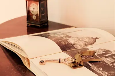 an open book on a table next to a clock at Il Tempio di Morfeo in Rome