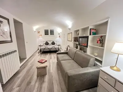 a living room with a couch and a television in it at Il Tempio di Morfeo in Rome