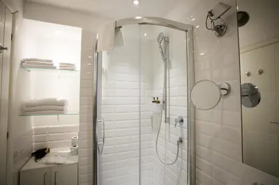 a shower with a glass door in a bathroom at Ripetta 25 Prestige Rooms in Rome