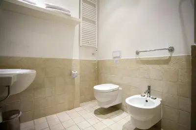 a bathroom with a toilet and a sink at Ripetta 25 Prestige Rooms in Rome