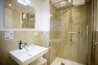 a bathroom with a sink and a shower at Ripetta 25 Prestige Rooms in Rome