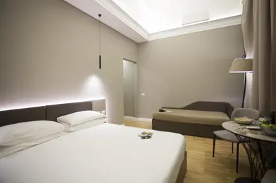 a hotel room with a bed and a couch at Ripetta 25 Prestige Rooms in Rome