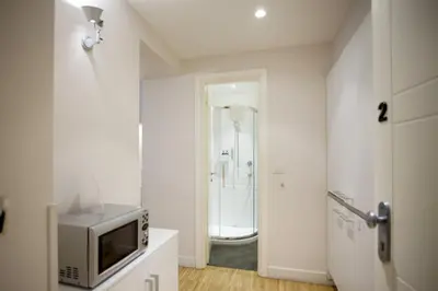 a bathroom with a television and a shower at Ripetta 25 Prestige Rooms in Rome
