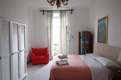a bedroom with a bed and a red chair at Interno 7 in Rome