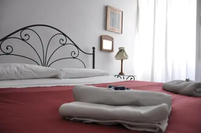 a bedroom with a large bed with a red blanket at Interno 7 in Rome