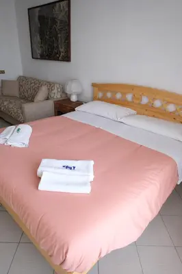 a bedroom with two beds with towels on the bed at Interno 7 in Rome