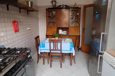 a kitchen with a table with chairs and a stove at Interno 7 in Rome