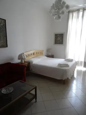a bedroom with a large white bed and a couch at Interno 7 in Rome