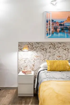 a white bedroom with a bed and a window at Vatican36 Guest House in Rome