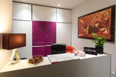 an office with a desk with a chair and a painting at Chroma Italy - Chroma Pente in Rome